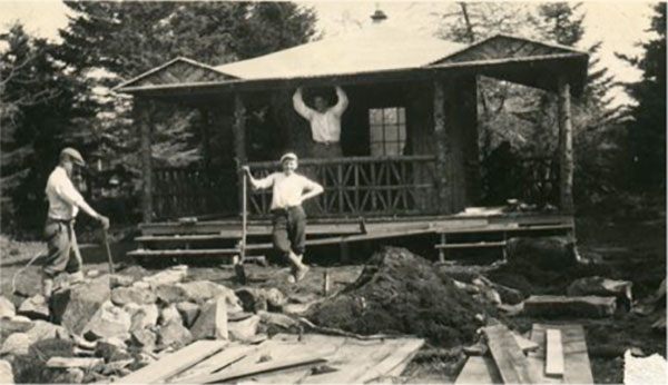 Workers constructing a pavilion in the grove